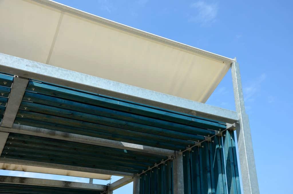 pergola of metal galvanized construction with blue planks in the side